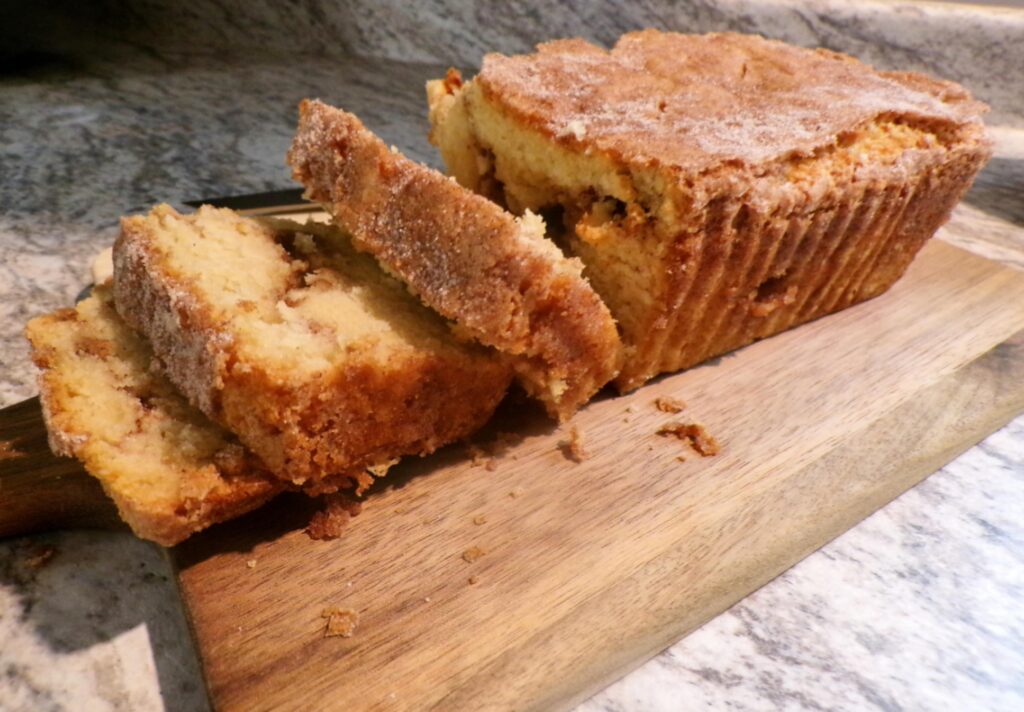 Sliced banana bread on a wooden board.
