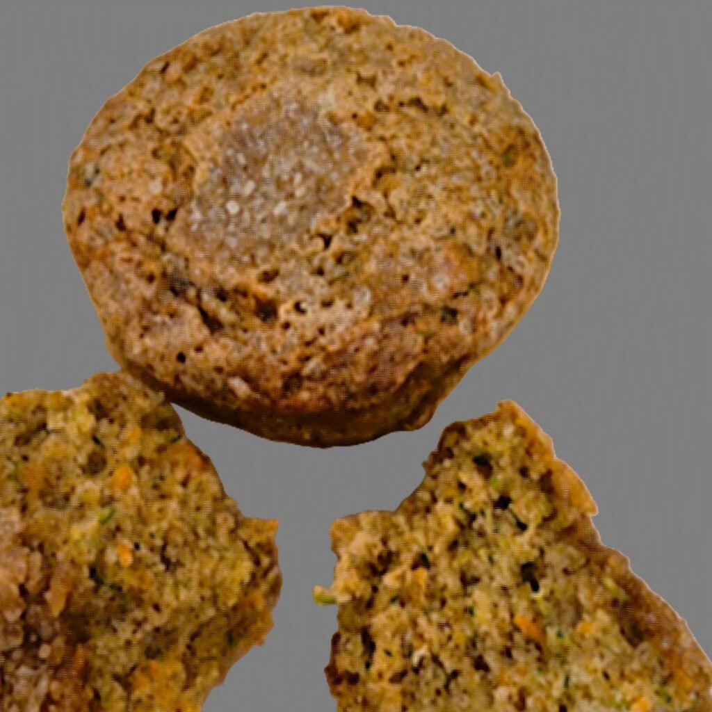 A close-up shot of three zucchini carrot muffins.